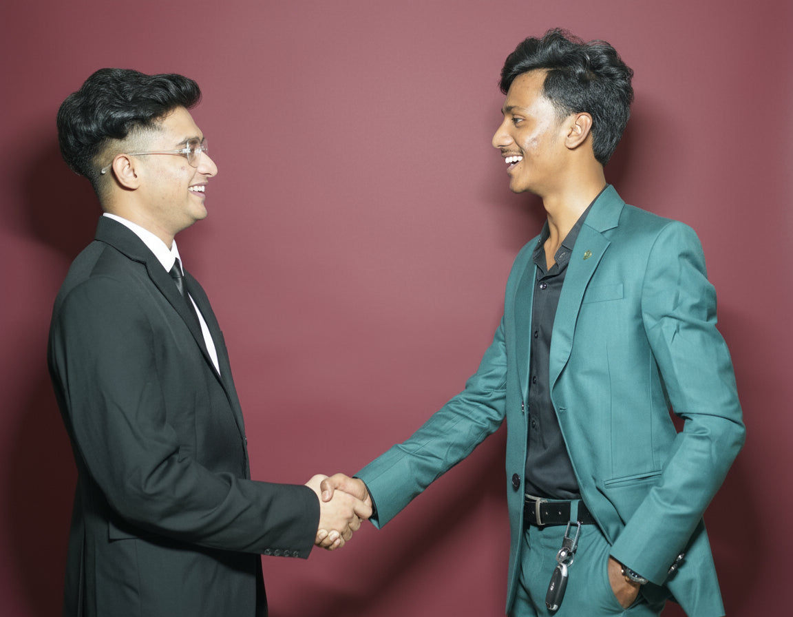 Two men in suits shaking hands against a white background